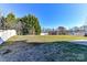 Spacious backyard with a grassy area and white fence at 7534 April Mist Trl, Huntersville, NC 28078