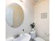 Clean and updated half bathroom with a large mirror at 7534 April Mist Trl, Huntersville, NC 28078