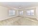 Bright bedroom with neutral walls, carpet, and multiple windows at 7534 April Mist Trl, Huntersville, NC 28078