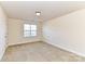 Bright bedroom with neutral walls and carpet at 7534 April Mist Trl, Huntersville, NC 28078