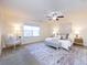 Spacious bedroom with carpeted floor, large windows, and ceiling fan at 7534 April Mist Trl, Huntersville, NC 28078