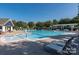 Inviting community pool with lounge chairs and a pergola at 7534 April Mist Trl, Huntersville, NC 28078