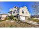 Two-story house with a brick and siding exterior, two-car garage, and landscaping at 7534 April Mist Trl, Huntersville, NC 28078