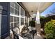 Inviting front porch with brick columns, two wicker chairs, and small table at 7534 April Mist Trl, Huntersville, NC 28078