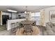 Open kitchen and dining area with bar seating and natural light from a window with bright curtains at 7534 April Mist Trl, Huntersville, NC 28078