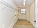 Laundry room with tile flooring and ample shelving at 7534 April Mist Trl, Huntersville, NC 28078