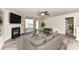 Spacious living room featuring a fireplace, neutral paint, and an abundance of natural light from a large window at 7534 April Mist Trl, Huntersville, NC 28078