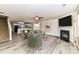 Open-concept living area featuring modern decor, fireplace, and natural light, blending comfort and style seamlessly at 7534 April Mist Trl, Huntersville, NC 28078