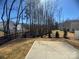 The backyard features newly planted trees and a concrete patio at 8205 Stonemere Ln, Charlotte, NC 28215