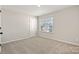 This bedroom features neutral walls, carpeted floor, one window, and a closet at 8205 Stonemere Ln, Charlotte, NC 28215