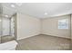 Bright bedroom with carpeting, neutral walls, and a double window at 8205 Stonemere Ln, Charlotte, NC 28215