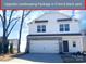 Charming two-story home featuring stone accents, a two-car garage, and manicured landscaping at 8205 Stonemere Ln, Charlotte, NC 28215