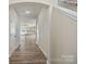 Inviting hallway with wood-look floors leading to the kitchen and other living spaces at 8205 Stonemere Ln, Charlotte, NC 28215