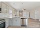 The kitchen includes granite countertops, stainless appliances, and gray cabinets, and view to main level at 8205 Stonemere Ln, Charlotte, NC 28215