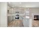 The kitchen features stainless appliances, gray cabinets, granite countertops, and a view to the fireplace at 8205 Stonemere Ln, Charlotte, NC 28215