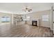 Well-lit living room showcases a cozy fireplace, hardwood floors, and modern kitchen bar at 8205 Stonemere Ln, Charlotte, NC 28215