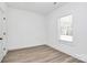 Bright bedroom with laminate floors, neutral walls, and a window at 872 Old Mocksville Rd # 1, Statesville, NC 28625