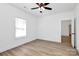 Bedroom features wood-look vinyl flooring, a ceiling fan, and a large window at 872 Old Mocksville Rd # 1, Statesville, NC 28625