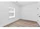 Well-lit bedroom with a window, neutral walls, and laminate wood flooring at 872 Old Mocksville Rd # 1, Statesville, NC 28625