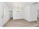 Bright dining room with wood vinyl flooring and a modern chandelier at 872 Old Mocksville Rd # 1, Statesville, NC 28625