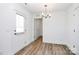 Bright entryway with wood-look floors, chandelier, and door to exterior at 872 Old Mocksville Rd # 1, Statesville, NC 28625