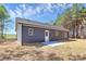 Back exterior view showcasing the siding, door, and small patio space at 872 Old Mocksville Rd # 1, Statesville, NC 28625