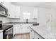 Bright kitchen featuring granite countertops, white cabinetry, stainless steel appliances, and a pantry at 872 Old Mocksville Rd # 1, Statesville, NC 28625