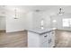 Open floor plan featuring a kitchen island with granite countertop and wood vinyl flooring at 872 Old Mocksville Rd # 1, Statesville, NC 28625
