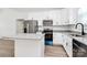 Kitchen featuring stainless steel appliances, an island, granite countertops, and white cabinets at 872 Old Mocksville Rd # 1, Statesville, NC 28625