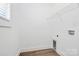 Empty laundry room featuring wood-look vinyl flooring, shelving, and washer-dryer hookups at 872 Old Mocksville Rd # 1, Statesville, NC 28625