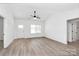 Sunlit living room showcasing modern design, neutral tones, and smooth flooring, transitioning to other rooms at 872 Old Mocksville Rd # 1, Statesville, NC 28625