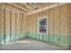 Unfinished room with exposed framing, wiring, and a single window at 872 Old Mocksville Rd # 1, Statesville, NC 28625