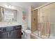 Bathroom featuring shower with glass door, granite vanity top, framed mirror, and coastal decor at 1236 Avalon Pl, Matthews, NC 28104