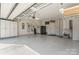 Garage featuring a black refrigerator, storage cabinets, tools hanging on the wall and epoxy floor at 1236 Avalon Pl, Matthews, NC 28104