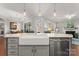 Well-lit kitchen showcasing a farmhouse sink, stainless steel dishwasher, and an open view to the living area at 1236 Avalon Pl, Matthews, NC 28104