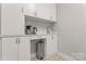 Functional kitchenette with white cabinets, a sink, and stainless steel appliances at 1236 Avalon Pl, Matthews, NC 28104