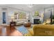 Living room with a fireplace, large windows, hardwood flooring, and neutral furniture at 1236 Avalon Pl, Matthews, NC 28104