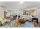 Living room with an open floor plan connecting to the kitchen, hardwood floors, and large windows at 1236 Avalon Pl, Matthews, NC 28104