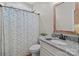 Clean bathroom with a granite vanity, updated fixtures, and a shower featuring a floral shower curtain at 170 Stillwater Rd, Richfield, NC 28137