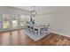 Bright dining room featuring hardwood floors, a charming chandelier, and natural light from the backyard at 170 Stillwater Rd, Richfield, NC 28137