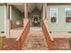 Welcoming front porch with a swing, decorated with holiday wreaths and a festive welcome mat at 170 Stillwater Rd, Richfield, NC 28137