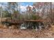 Scenic pond surrounded by mature trees, creating a tranquil and private natural setting at 170 Stillwater Rd, Richfield, NC 28137