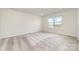 Bright and spacious bedroom with neutral carpeting and a large window at 3033 Eastcott Ave, Monroe, NC 28110