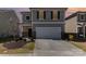 Two-story home with neutral siding, black shutters, two-car garage, and a well-maintained lawn at 3033 Eastcott Ave, Monroe, NC 28110