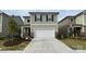 Two-story home with neutral siding, black shutters, two-car garage, and a well-maintained lawn at 3033 Eastcott Ave, Monroe, NC 28110