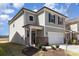 Two-story home featuring neutral siding, black shutters, a covered entryway, and manicured landscaping at 3033 Eastcott Ave, Monroe, NC 28110