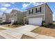 Two-story home with neutral siding, black shutters, two-car garage, and a well-maintained lawn at 3033 Eastcott Ave, Monroe, NC 28110