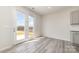 Sun-drenched living area with gray wood-look flooring and access to the outdoor patio at 3033 Eastcott Ave, Monroe, NC 28110