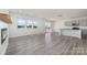 Open-concept living area with gray wood floors, large windows, and modern gray cabinets at 3033 Eastcott Ave, Monroe, NC 28110