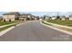 View of a quiet street with well-maintained sidewalks and landscaping at 3033 Eastcott Ave, Monroe, NC 28110